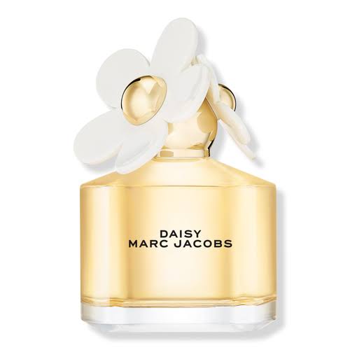 Marc Jacobs Daisy perfume bottle with a gold-toned glass body, a white daisy flower cap, and black text on the front, shown on a white background.